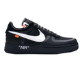 A black Nike Air Force 1 Low sneaker with a white Swoosh, featuring 'AIR' printed in white on the black midsole and a small orange accent tab near the collar.