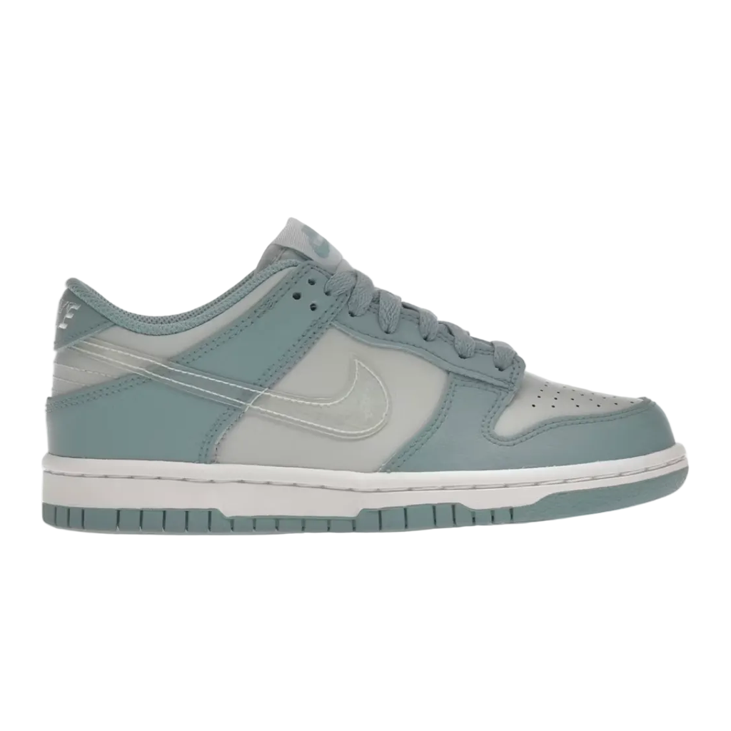 A Nike low-top sneaker shown in side profile on a white background, with a light blue-gray and white colorway. The shoe features a light blue-gray leather upper with white overlays, a white midsole, and a matching light blue-gray outsole.