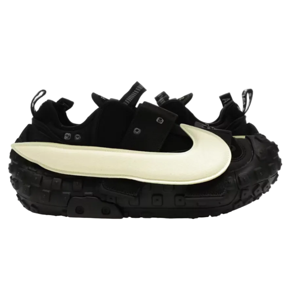 A black Nike sneaker with a thick, chunky black sole and a large, curved off-white Swoosh on the side, shown in profile against a plain white background.