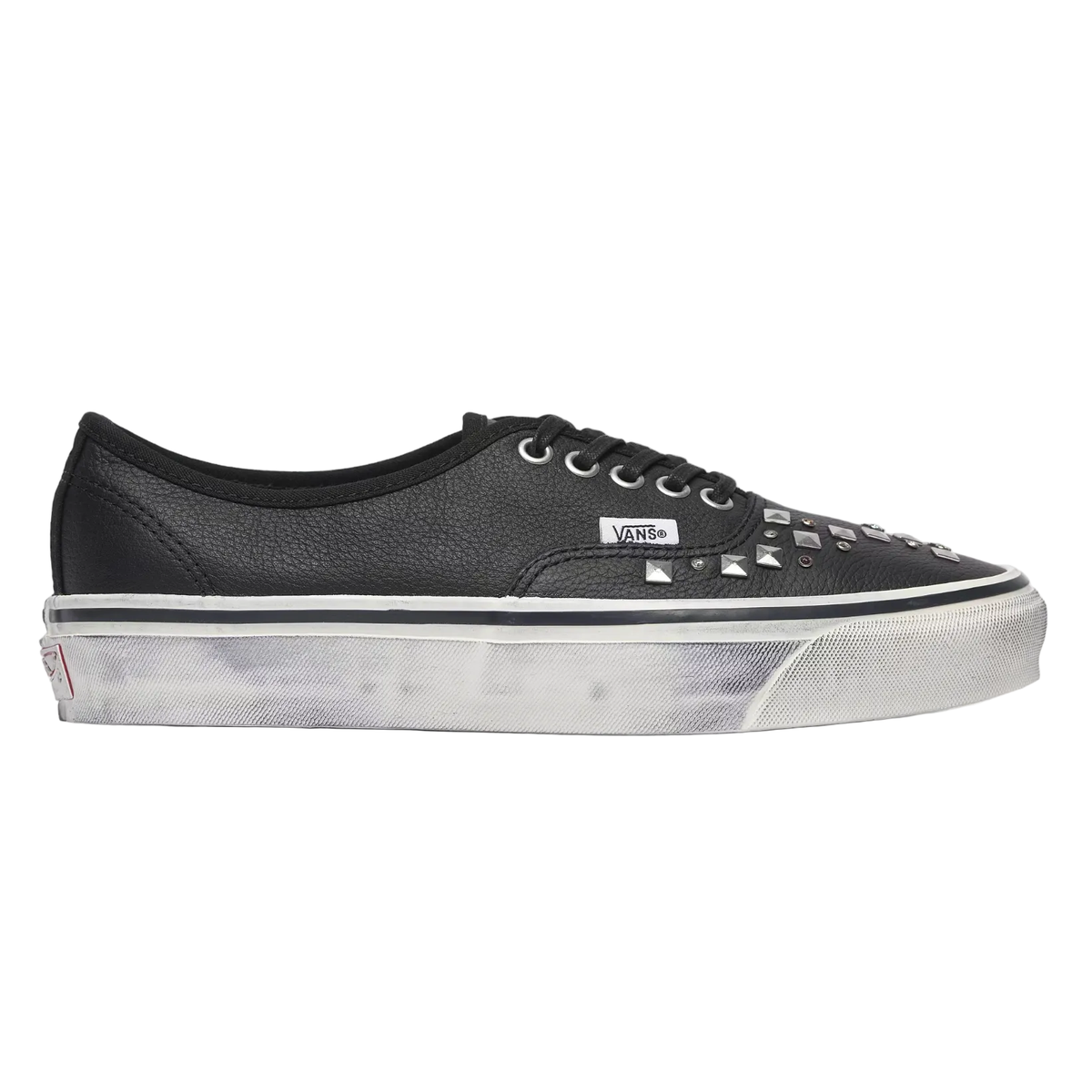 A black leather Vans platform sneaker with silver studs on the toe box, shown in a side profile against a light gray background.