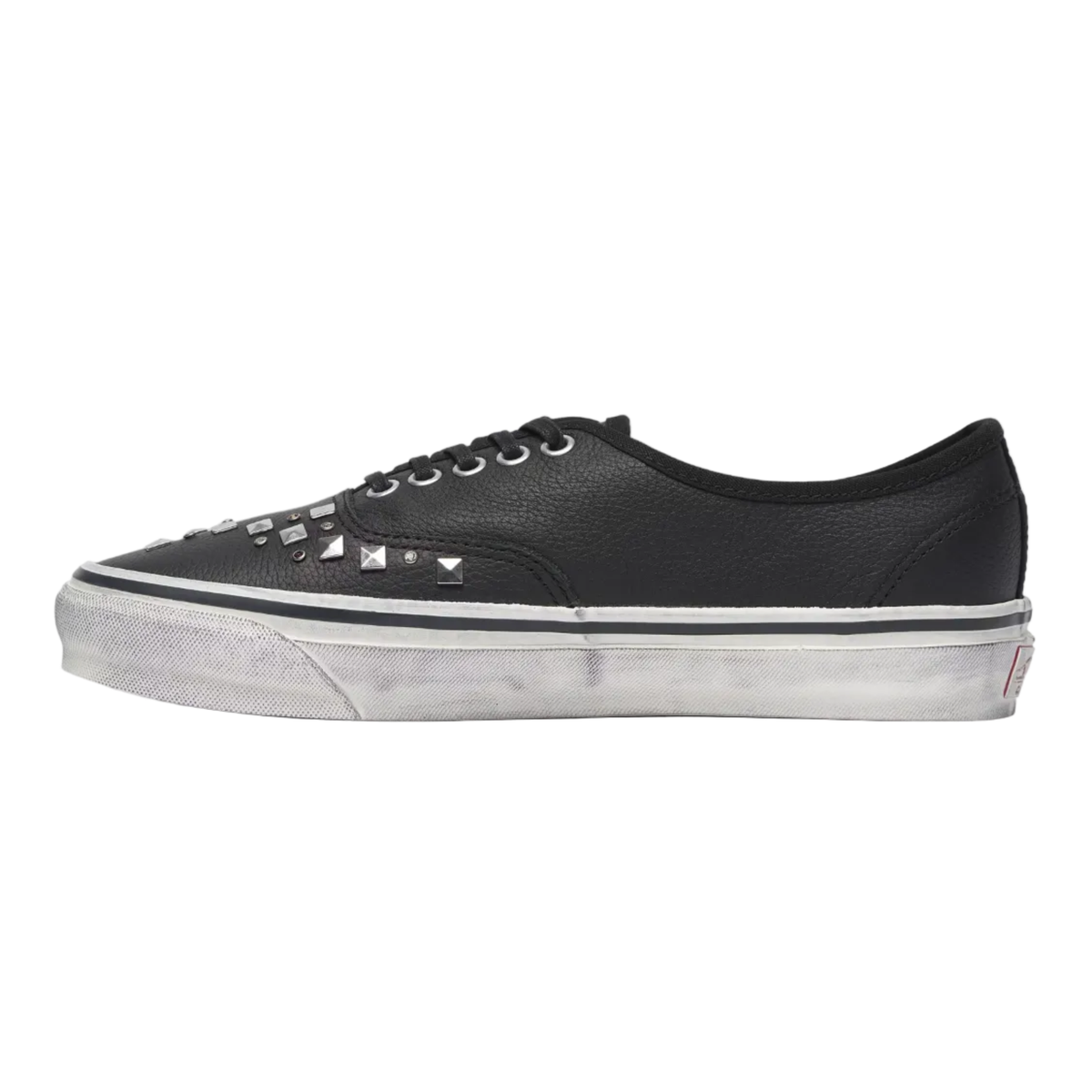 Black sneakers with white soles on a light gray background